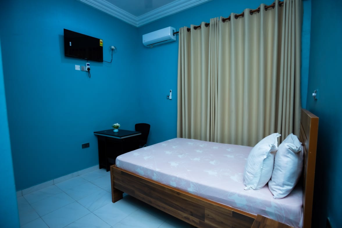 Block D Room showing bed, desk and private washroom entry