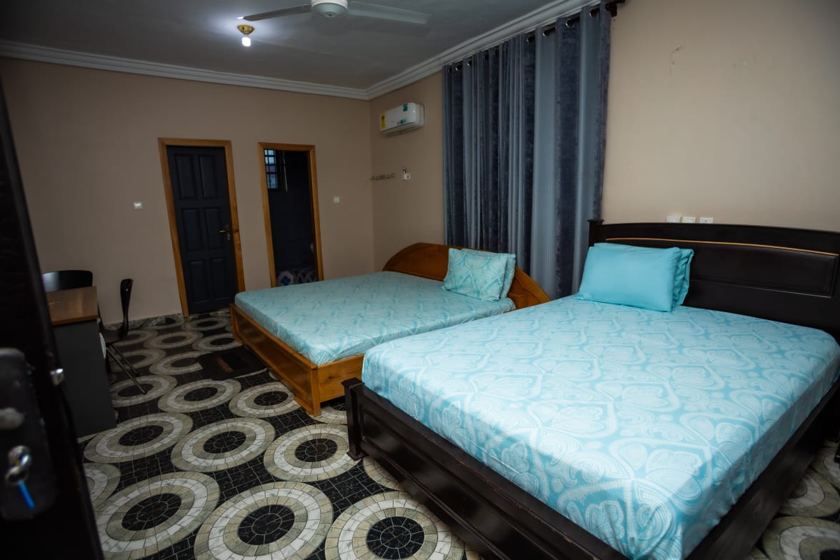 Room C6 Family Suite showing beds, desk and refrigerator