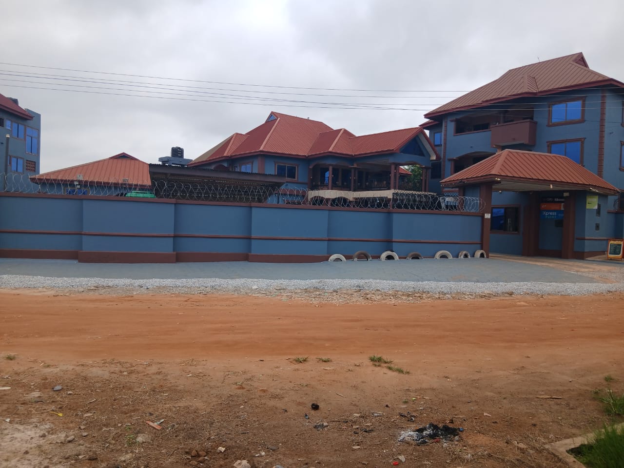 Paved courtyard and guest parking at Abank Village Guest House