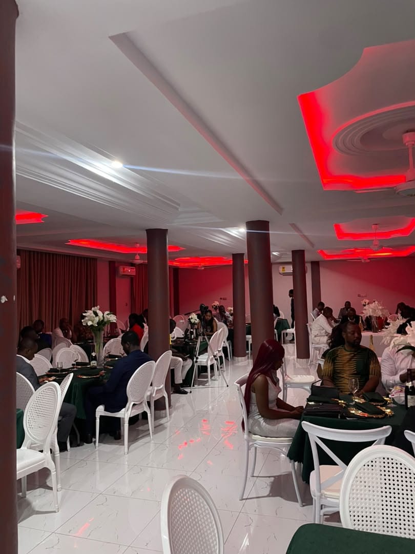 Abank Village dining hall set with green linen under red lighting